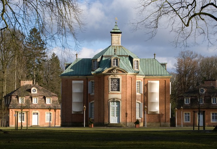 Zentralbau von Schloss Clemenswerth mit Wintereinhausungen der Steinskulpturen an der Fassade